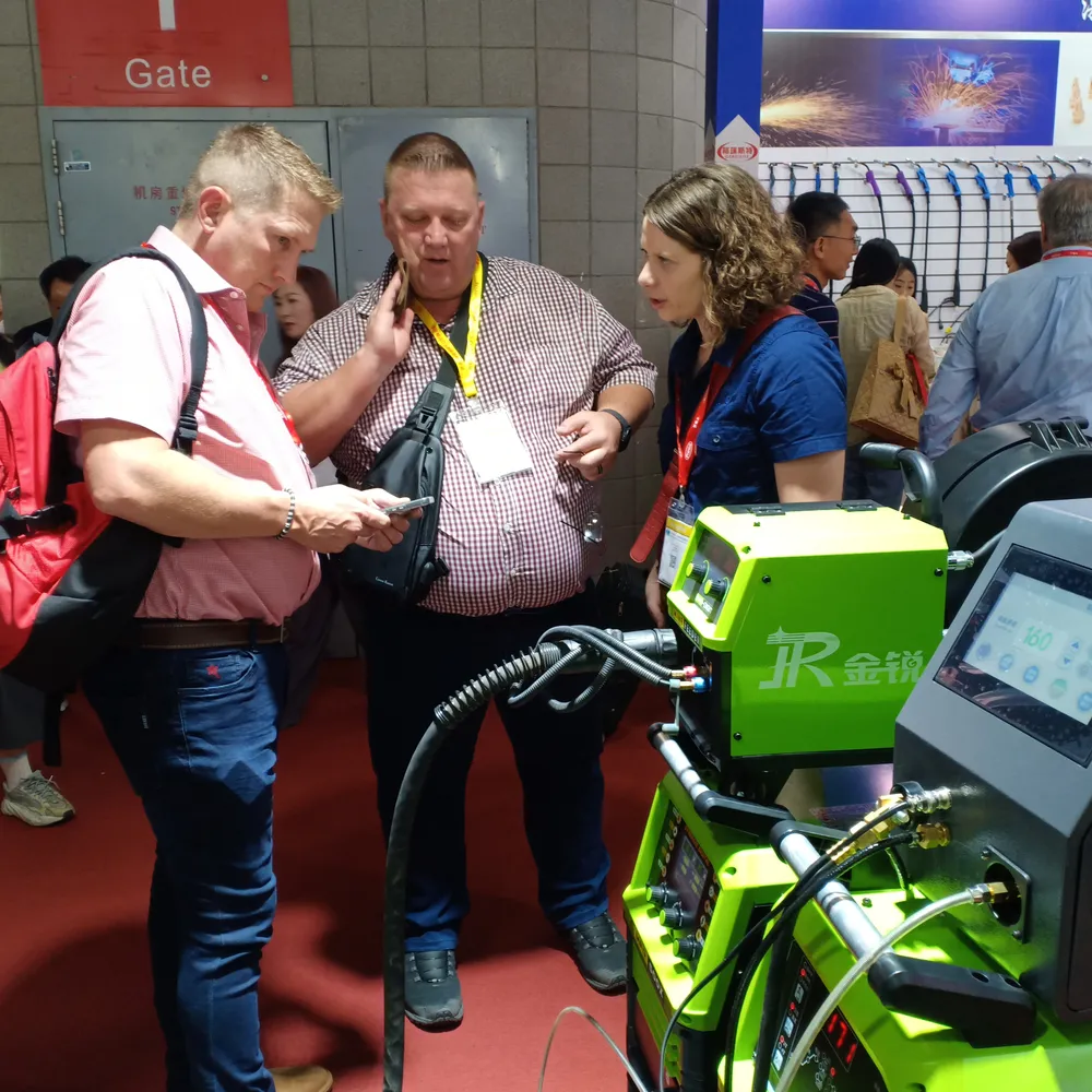 Distributor team and customers reviewing a welding machine during a live exhibition demo.