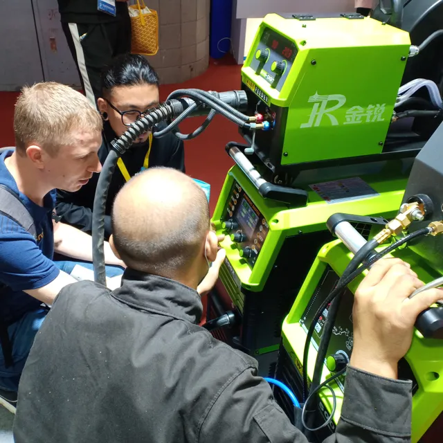 Visitors inspecting a welding machine control panel at Beijing Essen