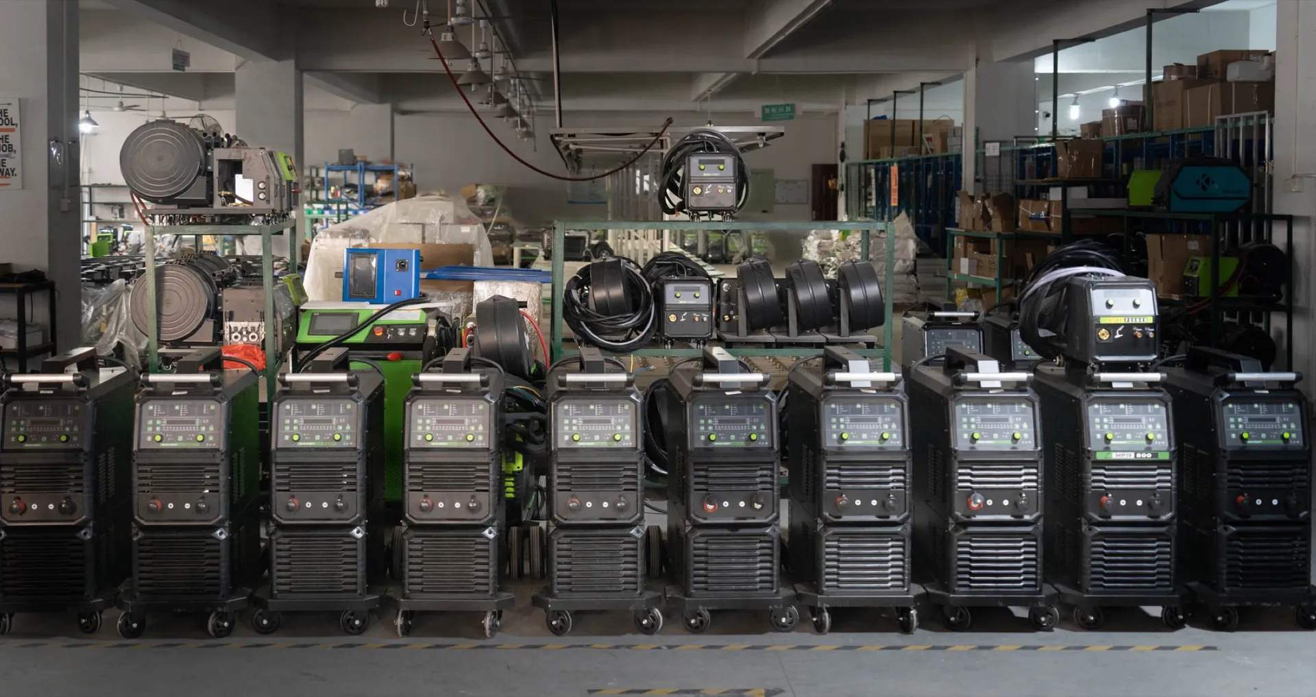 Row of workshop MIG welding machines prepared for comparing output classes and workload.