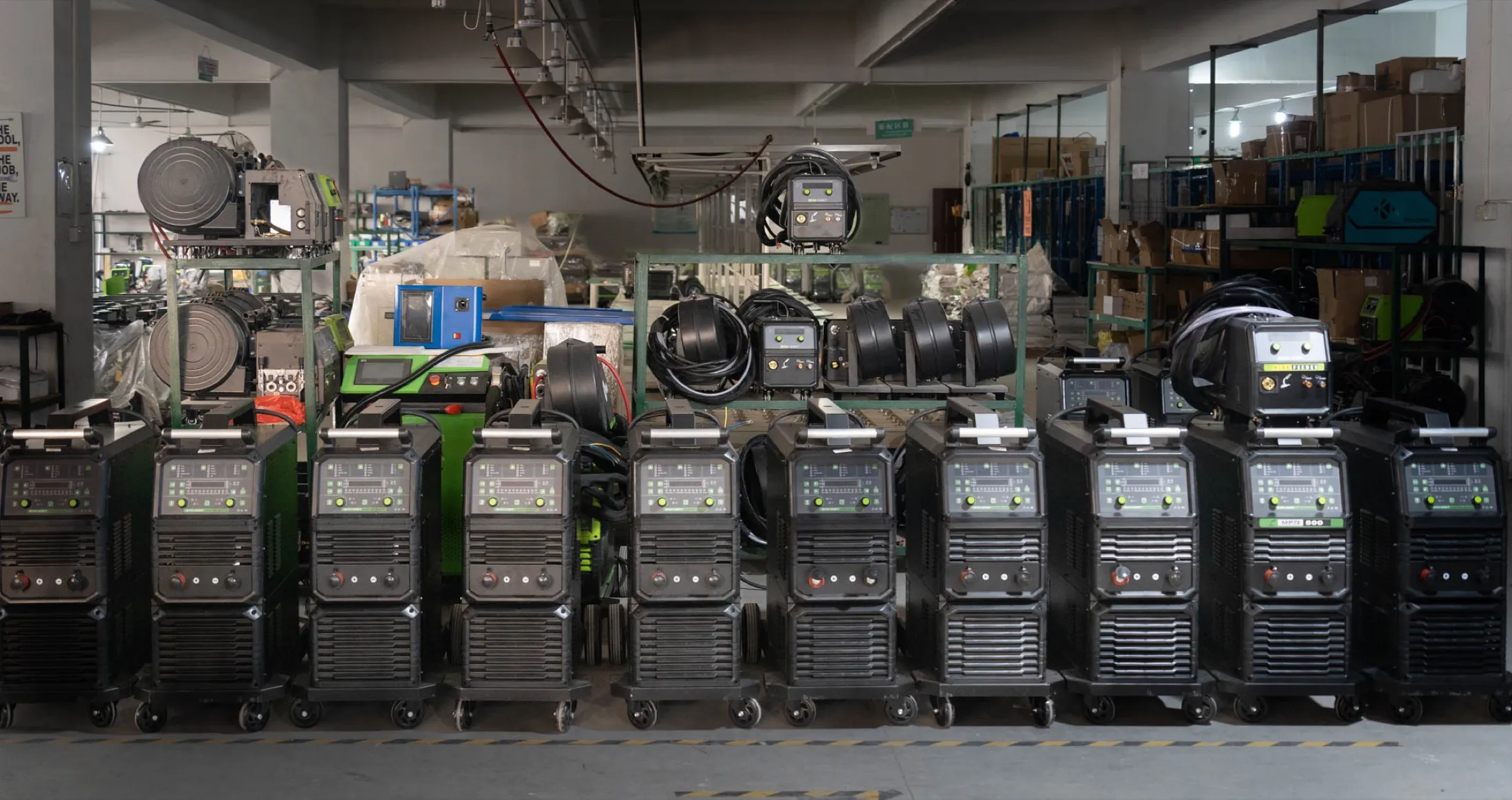 Row of workshop MIG welding machines prepared for comparing output classes and workload.