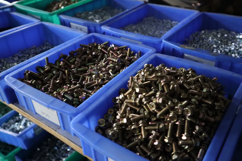 Workshop parts bins and small hardware used to prepare precise welding equipment RFQ details.