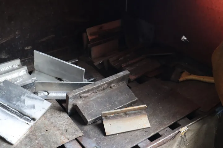 Welded metal test pieces on a workshop bench